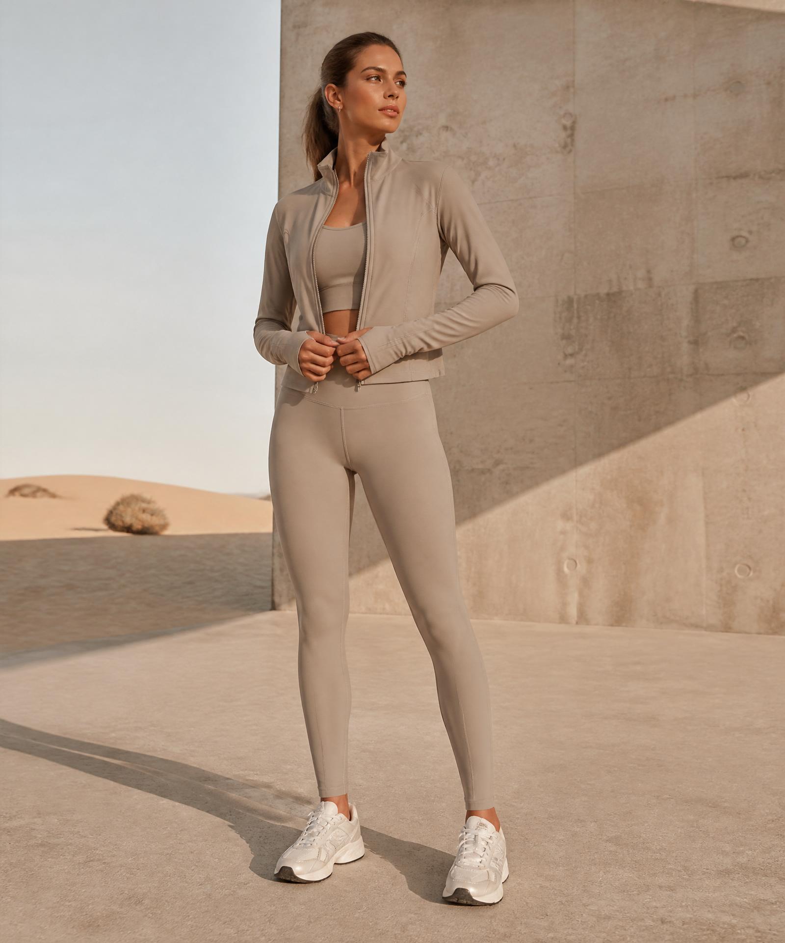 Woman wearing the Rebel Paddie Everyday Performance Jacket in sand